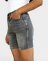 Gray denim shorts worn by a person on a white background