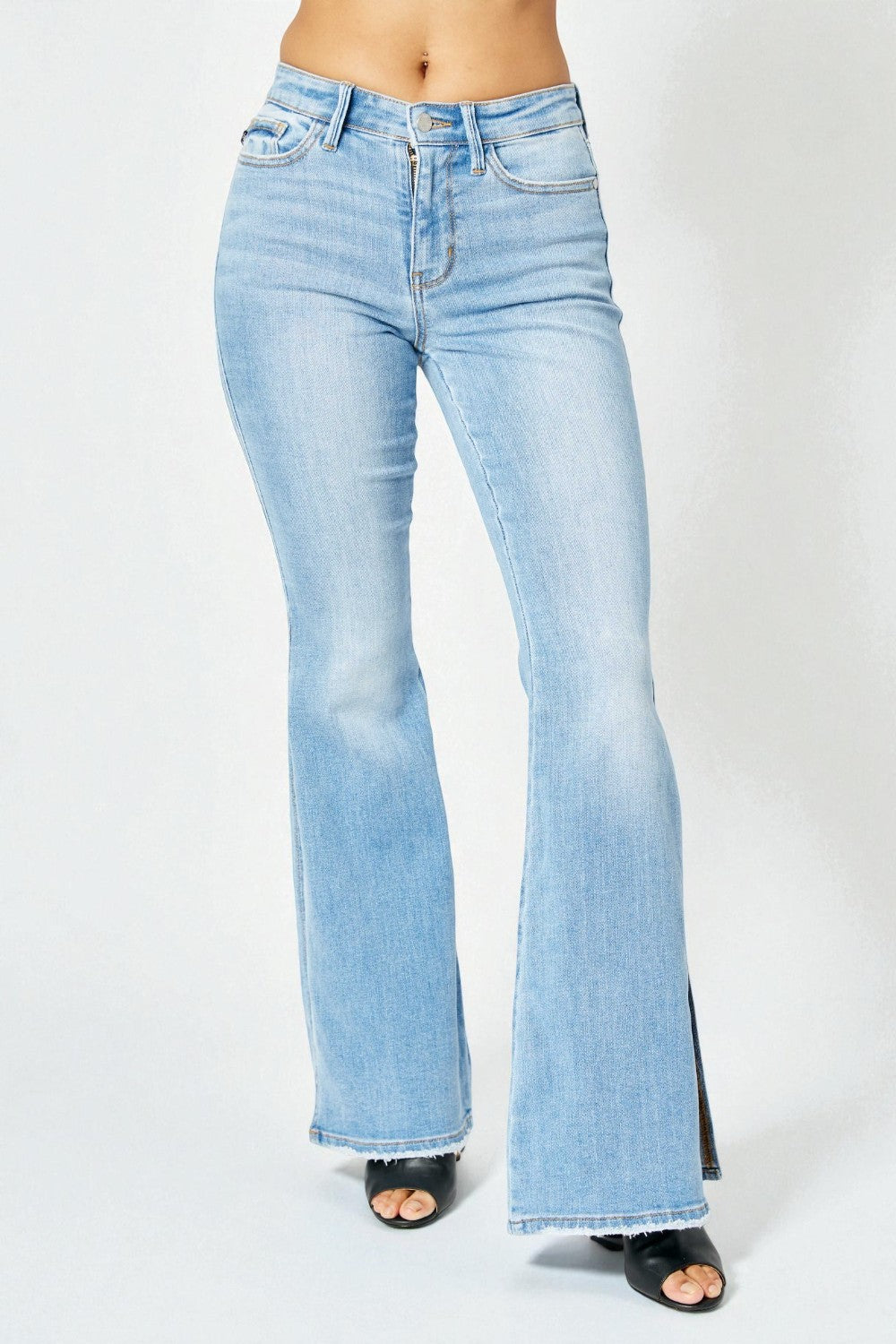 Light blue flared jeans on a white background