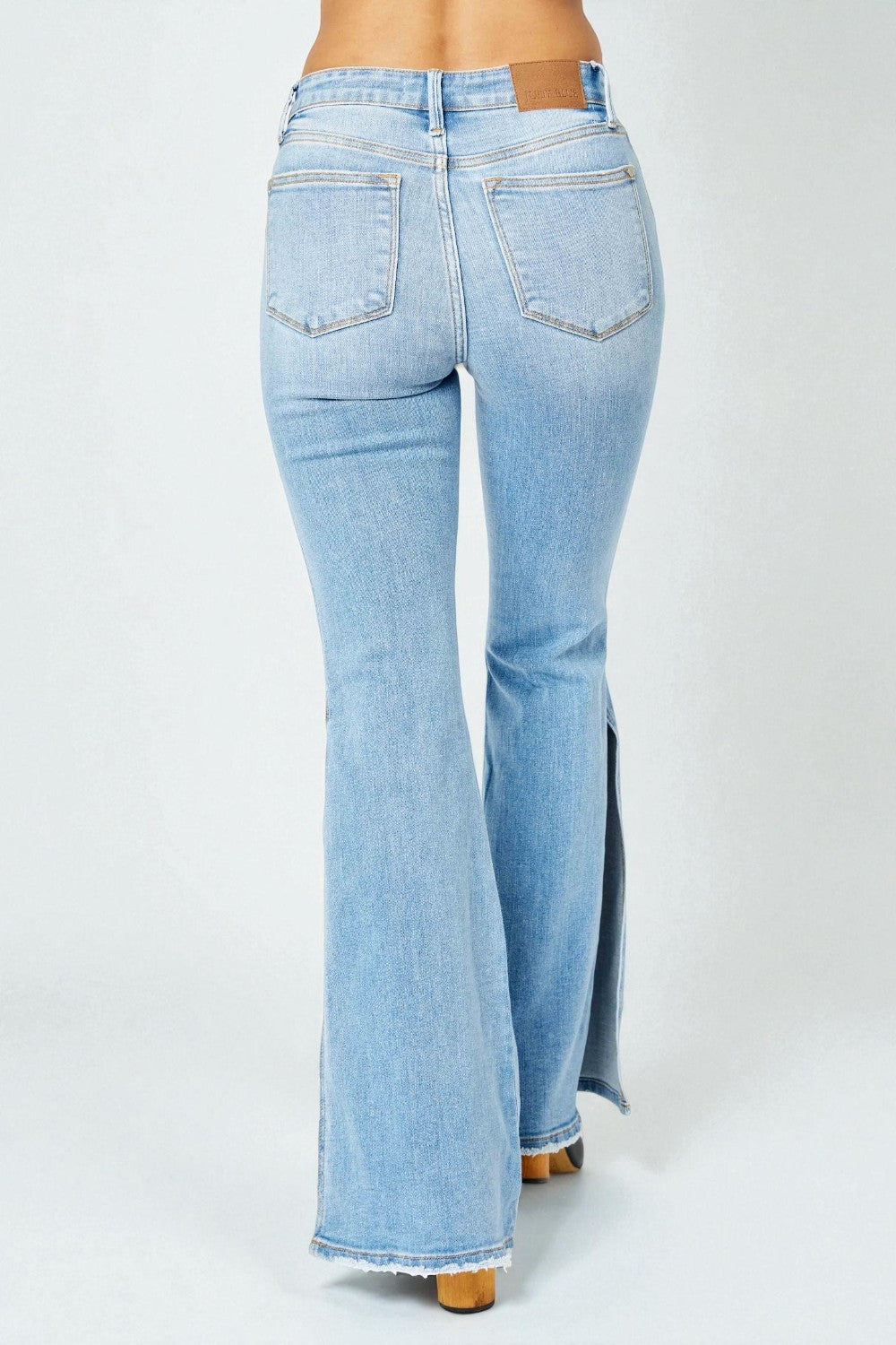 Light blue flared jeans on a white background