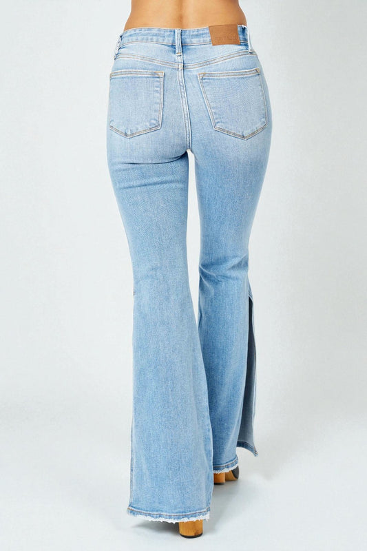 Light blue flared jeans on a white background