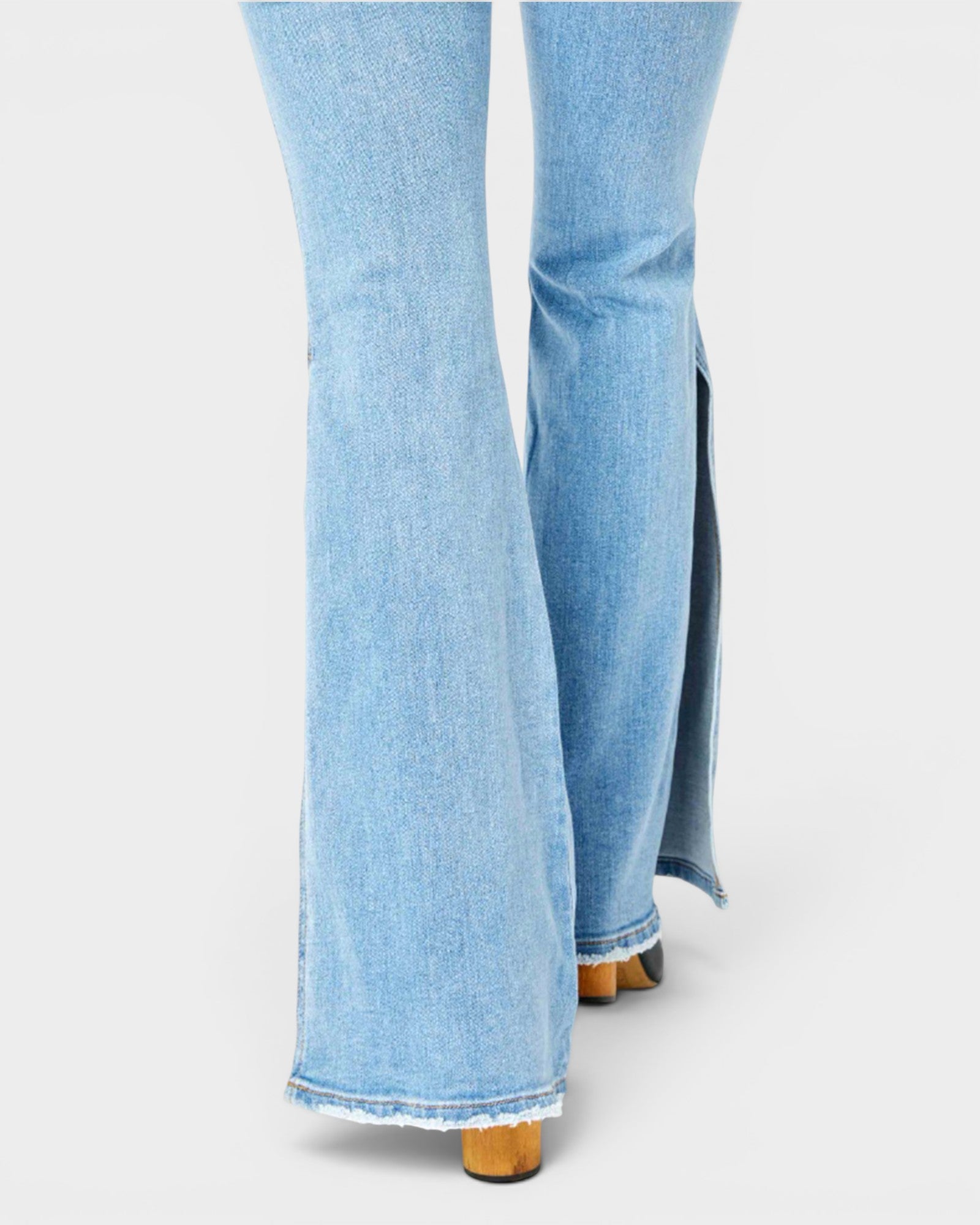 Light blue jeans with a slit on a white background