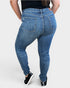 Person wearing blue jeans on a white background