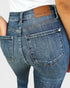 Close-up of blue jeans with a Judy Blue label on a white background
