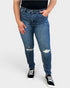 Person wearing blue jeans with slight distressing on a white background
