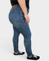 Person wearing blue jeans on a white background