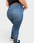 Person wearing blue jeans on a plain background
