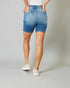 Person wearing blue denim shorts on a plain background