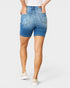 Person wearing blue denim shorts on a white background