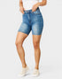 Person wearing blue denim shorts on a white background