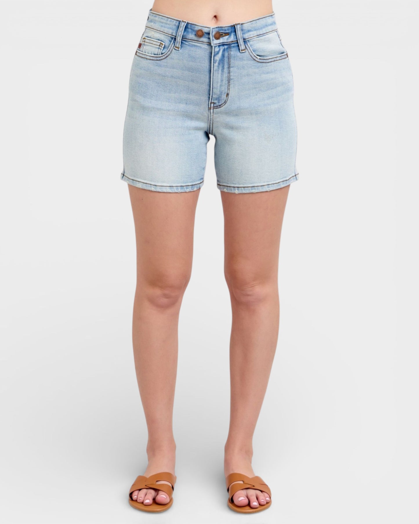 Light blue denim shorts worn by a person on a white background