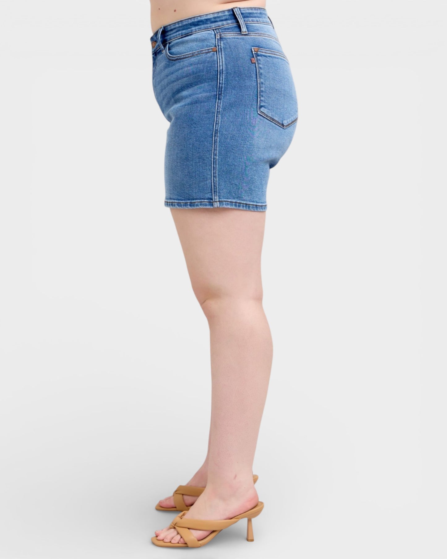 Light blue denim shorts worn by a person on a white background