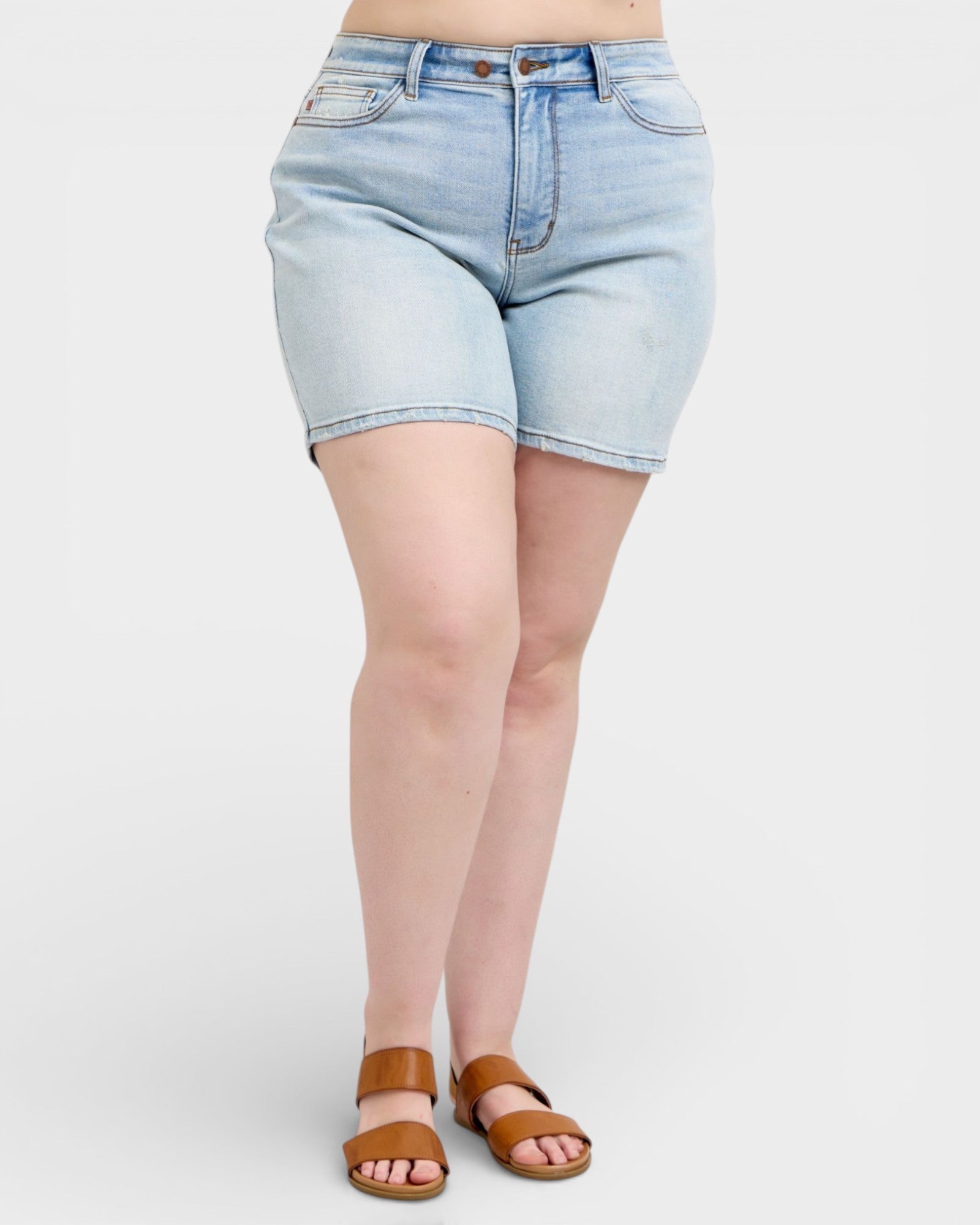 Light blue denim shorts worn by a person on a white background