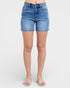 Blue denim shorts worn by a person on a white background