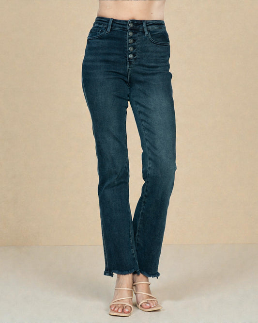 Dark blue jeans worn by a person on a beige background