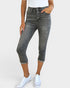 Person wearing gray jeans and white sneakers on a plain background