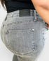Gray jeans with a brand label on a white background