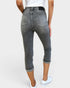 Person wearing gray capri jeans on a white background