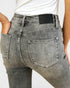 Gray jeans with a brand label on a white background