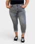 Person wearing gray high-waisted jeans with a plain background