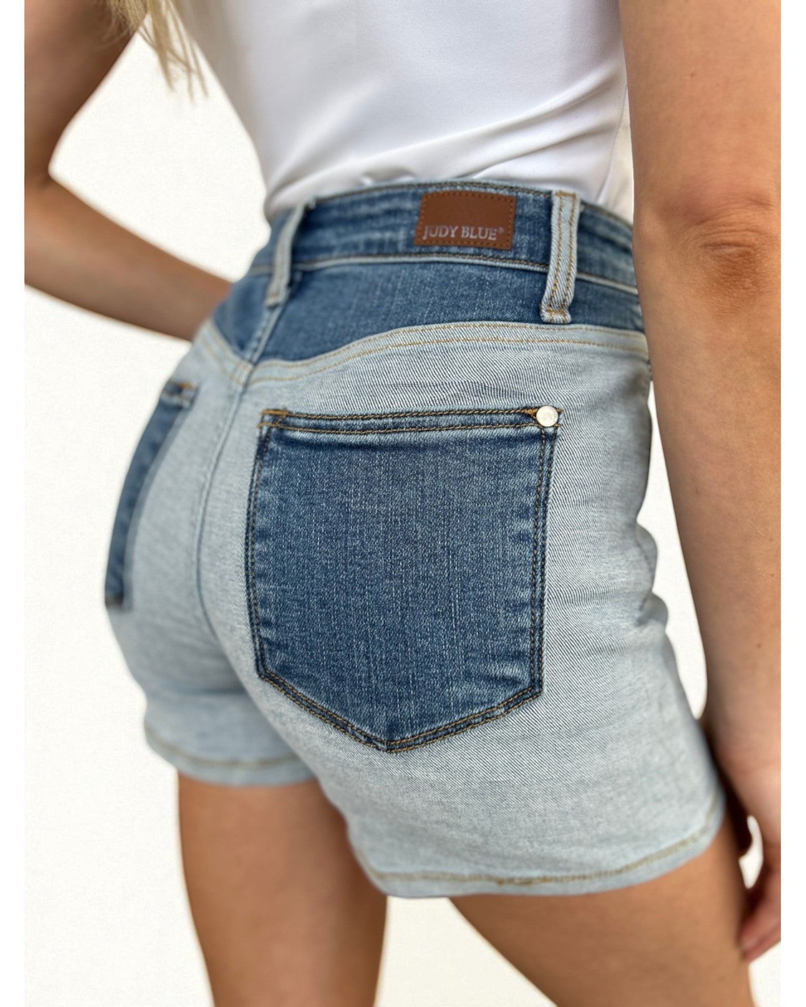 Denim shorts with a visible brand label on a plain background