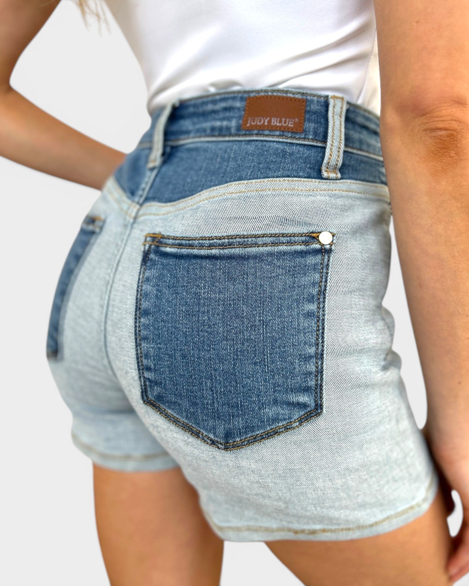 Denim shorts with a brand label on a plain background