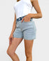 Person wearing light blue denim shorts on a white background