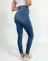 Person wearing blue jeans on a white background