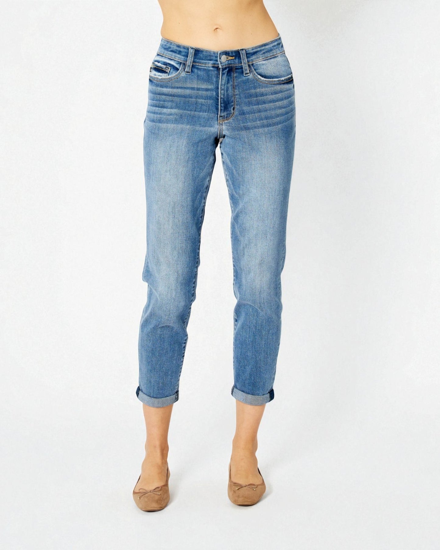 Blue jeans worn by a person on a white background