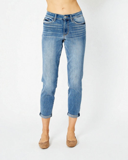 Blue jeans worn by a person on a white background