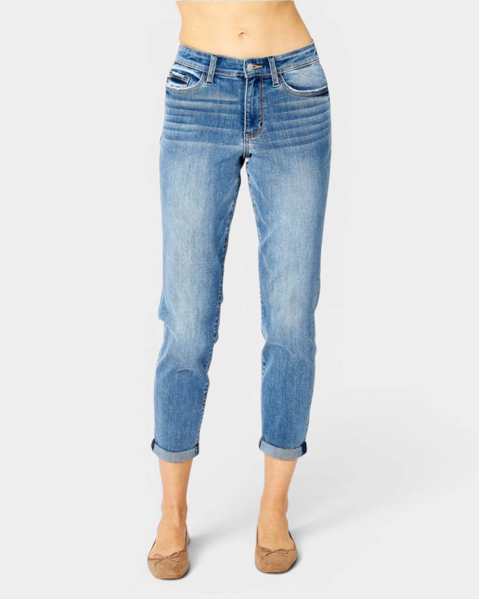 Blue jeans worn by a person on a white background