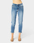 Blue jeans worn by a person on a white background