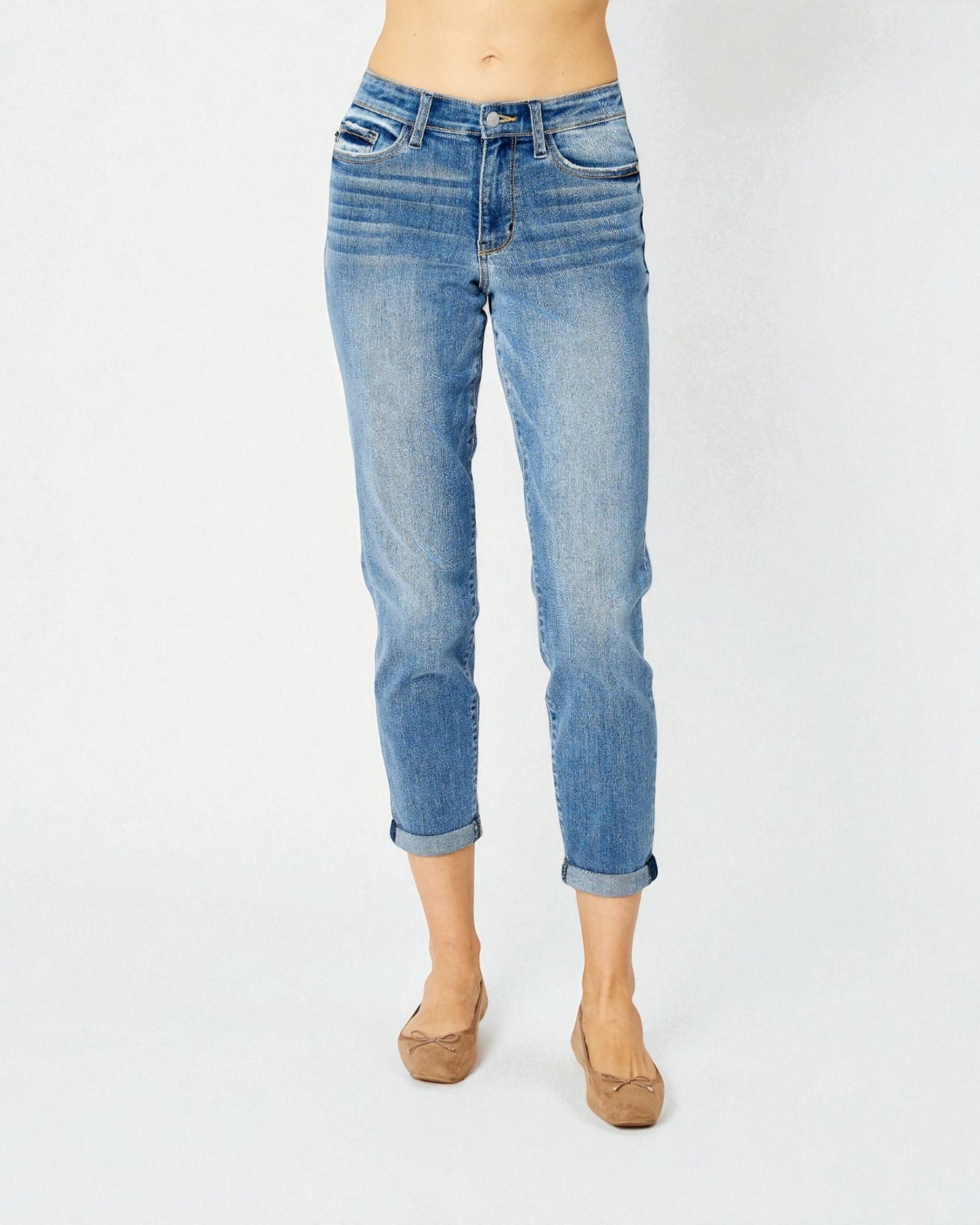 Blue jeans worn by a person on a white background