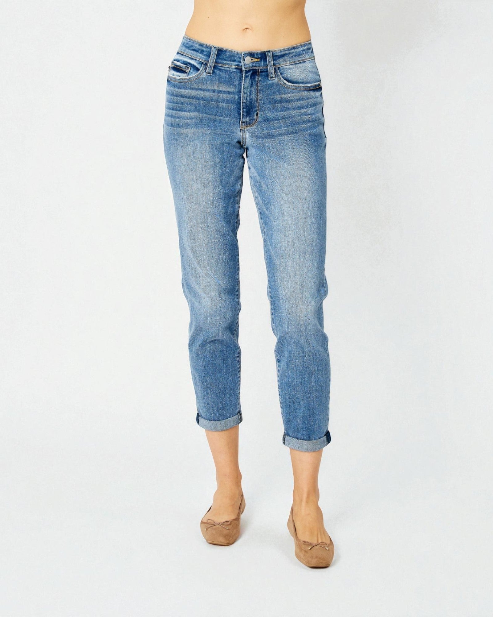 Blue jeans worn by a person on a white background