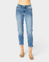 Blue jeans worn by a person on a white background