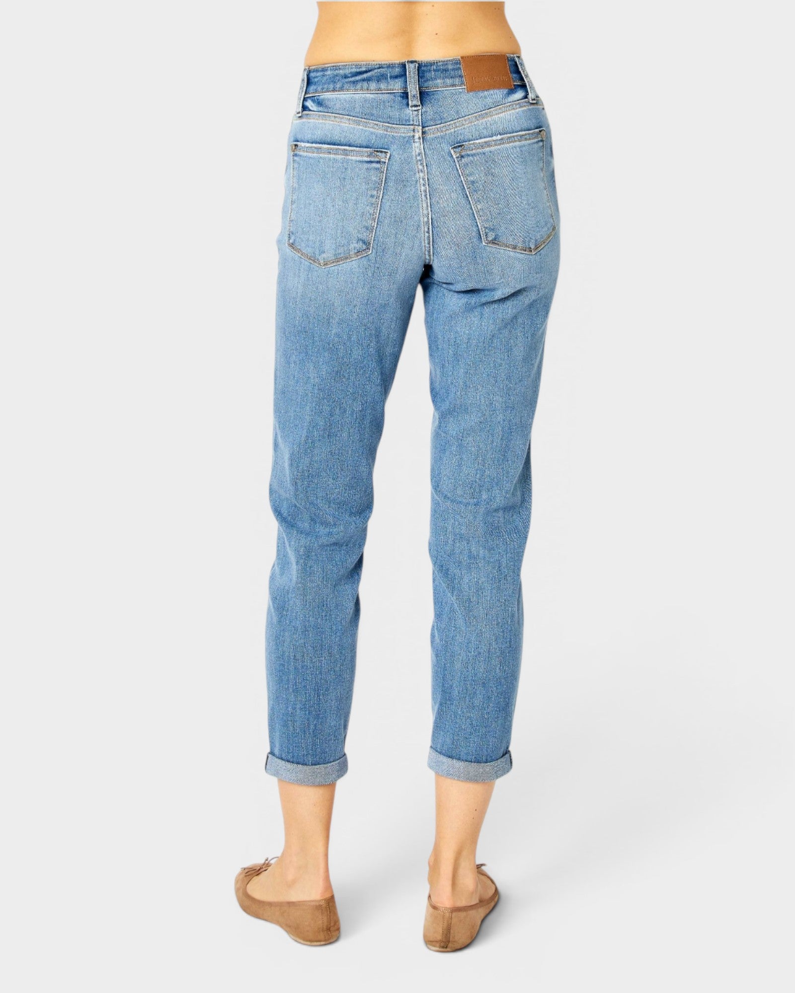 Light blue jeans worn by a person on a white background