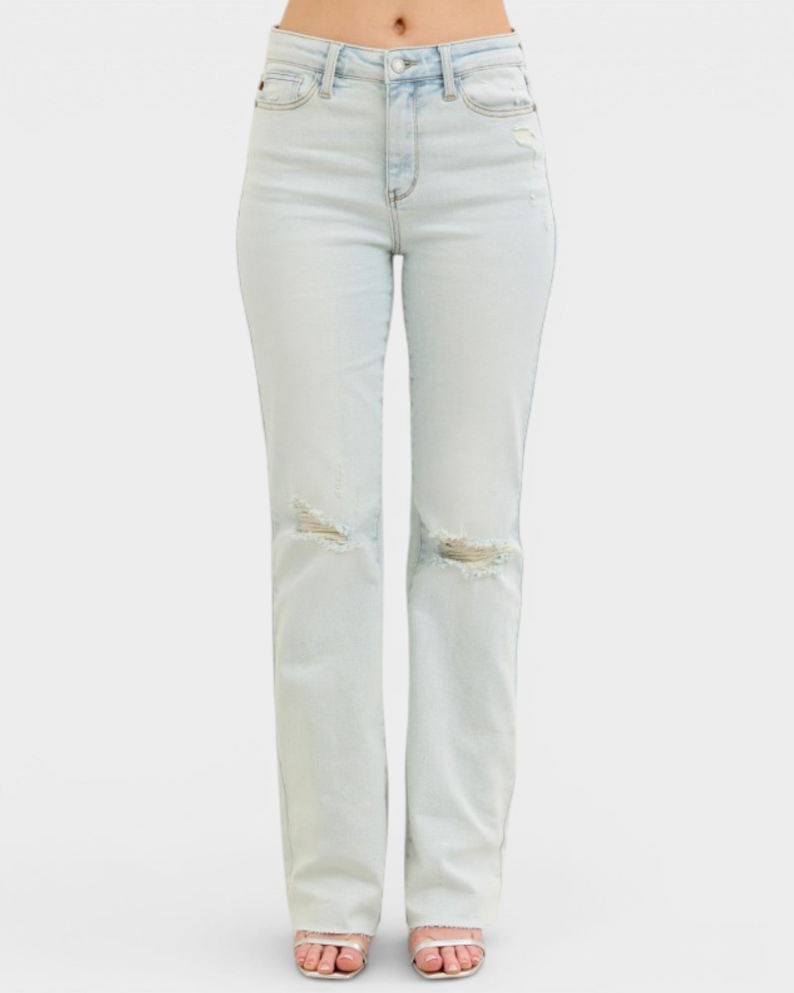 Light blue jeans with slight distressing on a white background