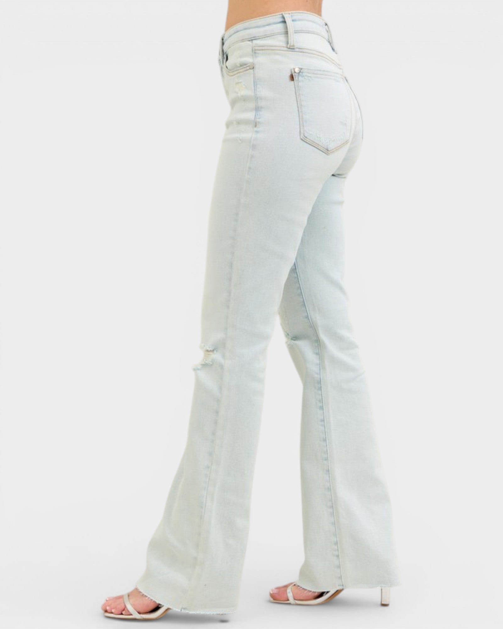 Light blue flared jeans on a white background