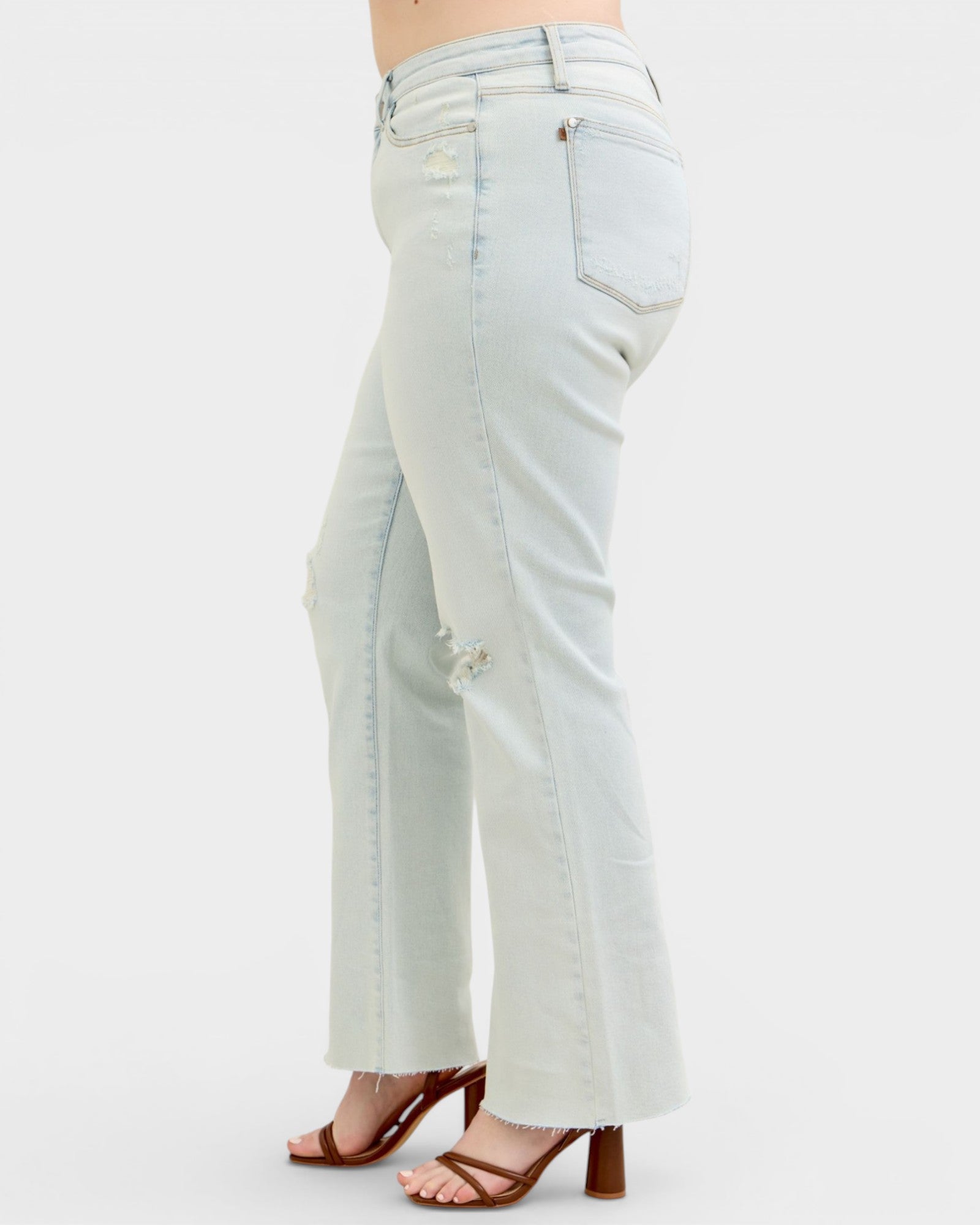 Light blue jeans worn by a person on a white background