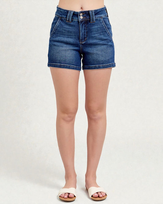 Blue denim shorts worn by a person on a white background