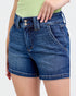 Blue denim shorts worn by a person on a white background