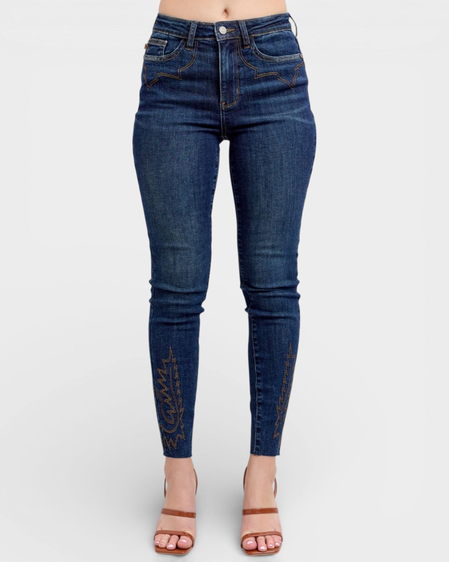 Blue jeans worn by a person on a white background