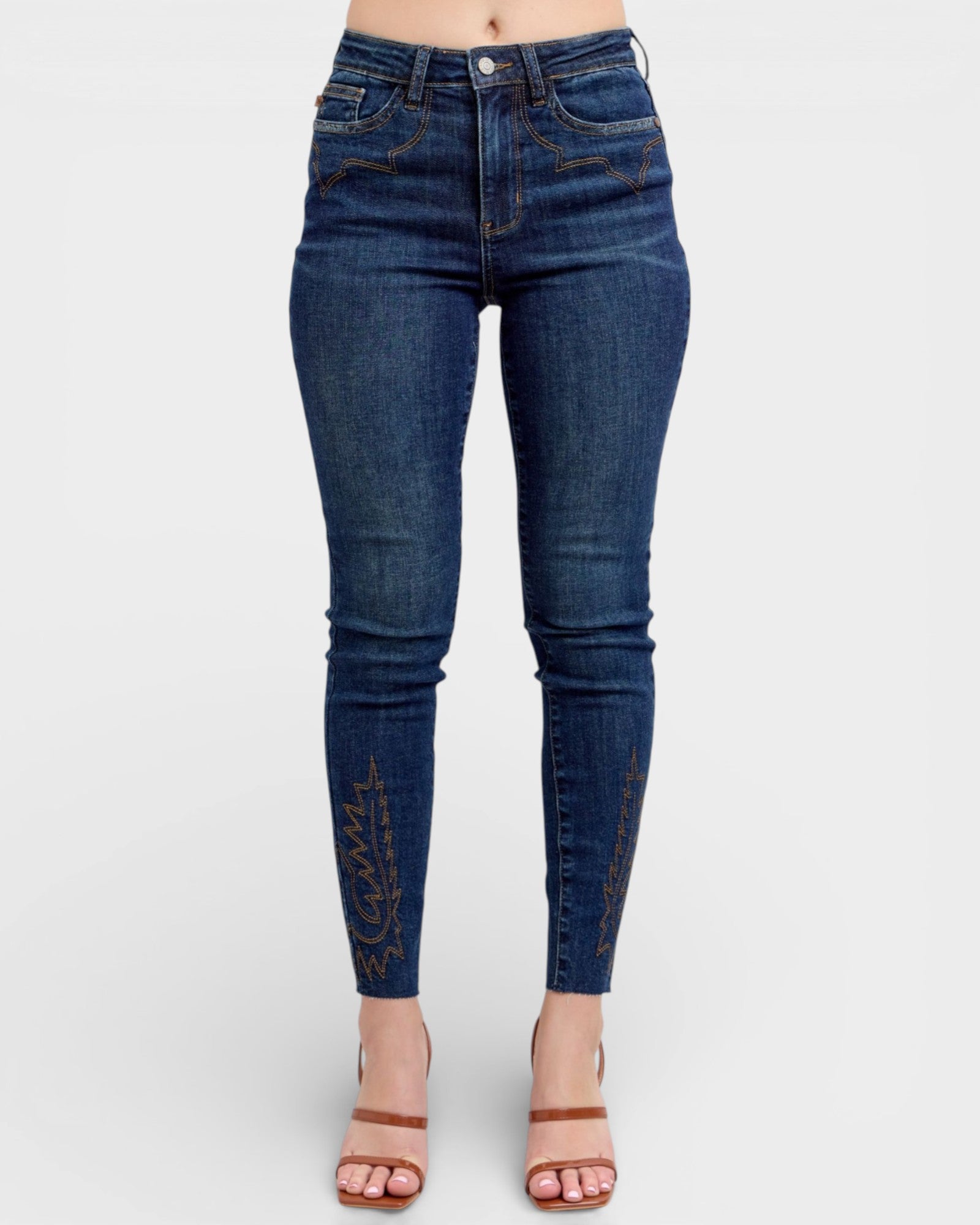 Blue jeans worn by a person on a white background