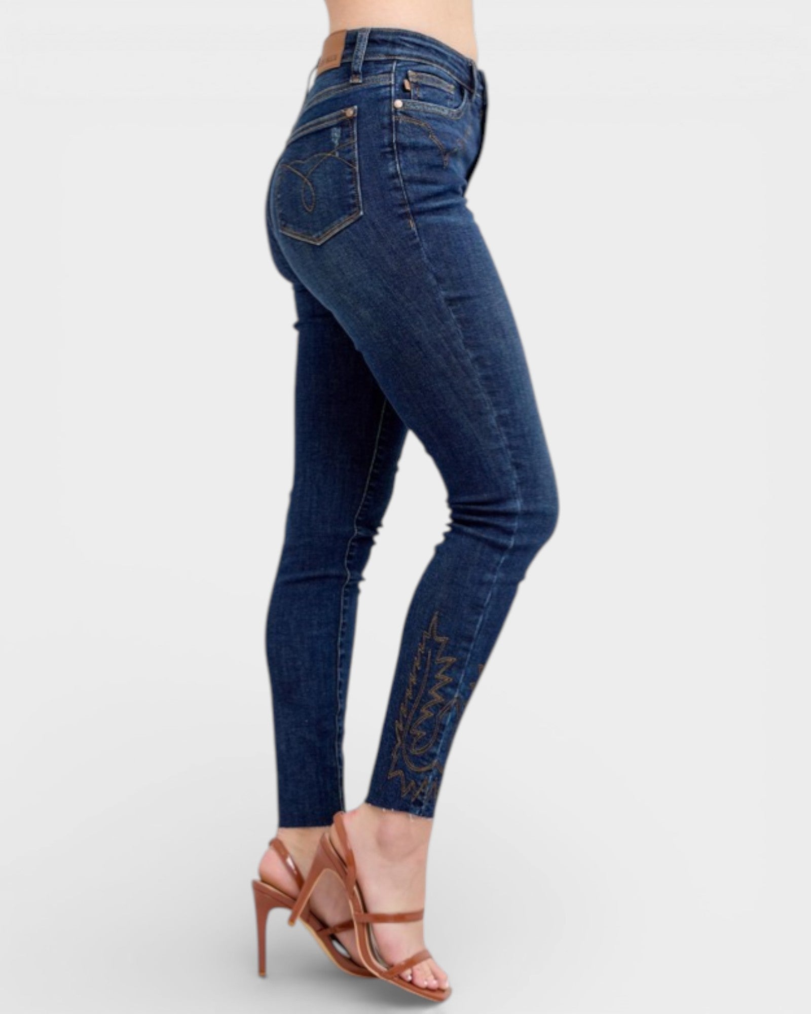 Blue jeans worn by a person on a white background