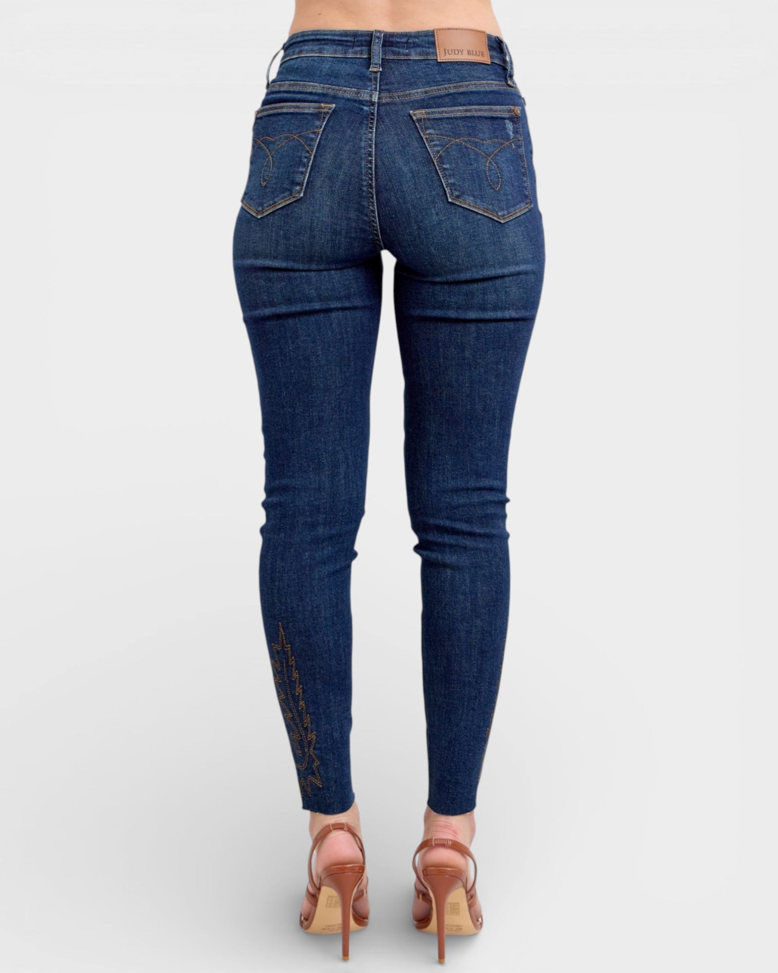 Blue jeans worn by a person on a white background