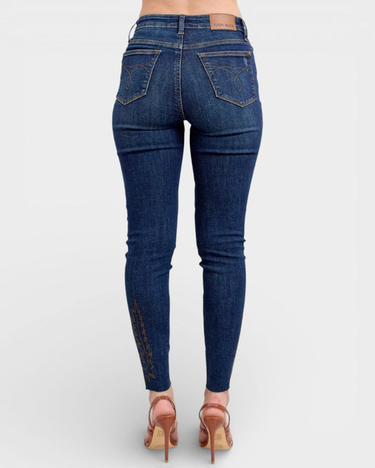 Blue jeans worn by a person on a white background