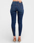 Blue jeans worn by a person on a white background