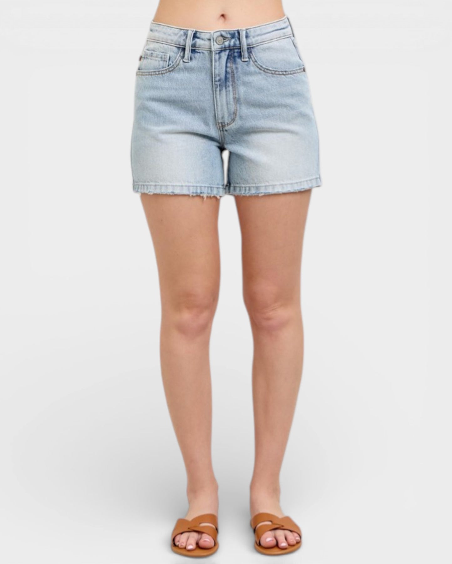 Light blue denim shorts worn by a person on a white background