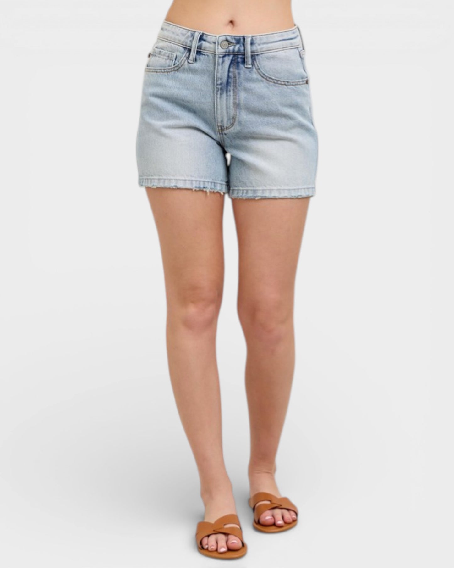 Light blue denim shorts worn by a person on a white background