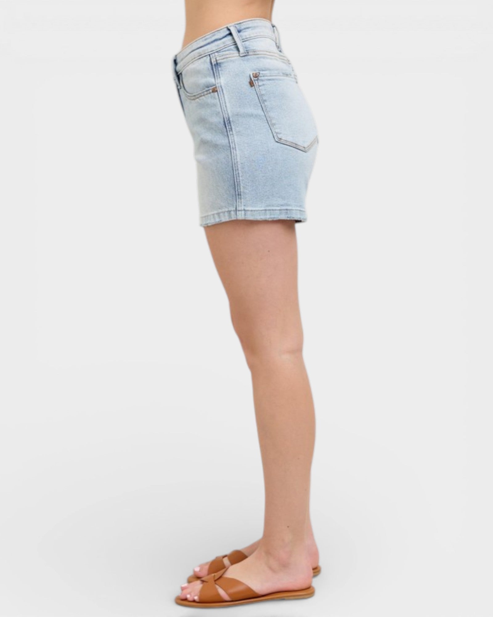 Light blue denim shorts worn by a person on a white background