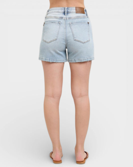 Light blue denim shorts worn by a person on a white background
